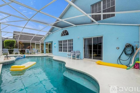 A swimming pool inside a house with a yellow float in the water.