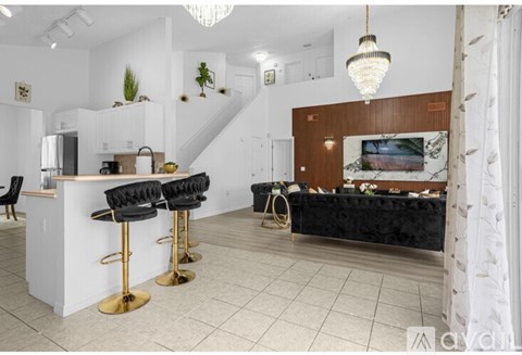 A dining room with a black table and chairs.