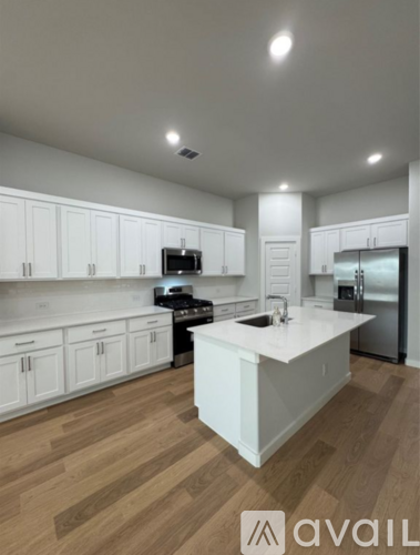 A kitchen with white cabinets and a central island.