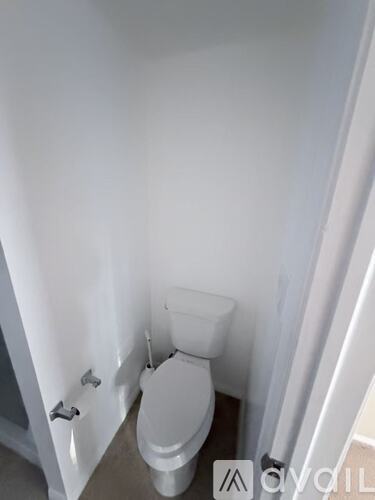 A white toilet in a small bathroom.