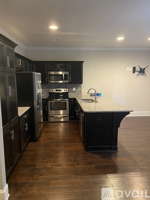 A kitchen with dark wood cabinets and a white countertop.