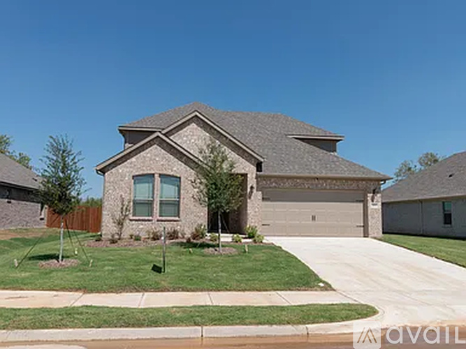 A house with a brown roof and a grey garage door.