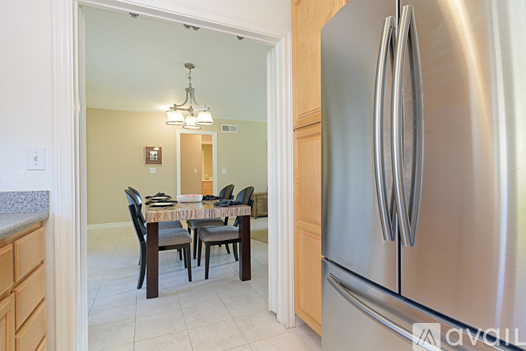 A kitchen with a table and chairs in the middle of the room.