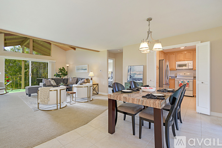 A modern dining room with a table set for six.