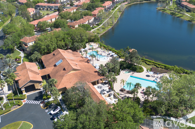A bird's eye view of a resort with a swimming pool and a lake.