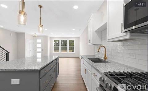 A modern kitchen with a stove top oven and a microwave above the counter.