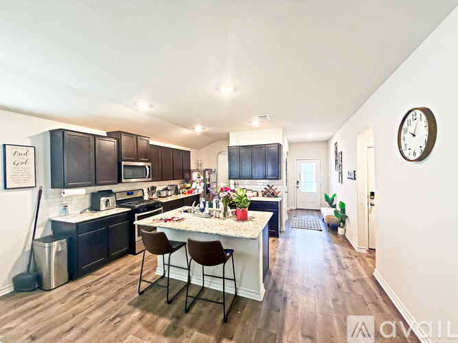 A kitchen with a table and chairs in the middle of the room.