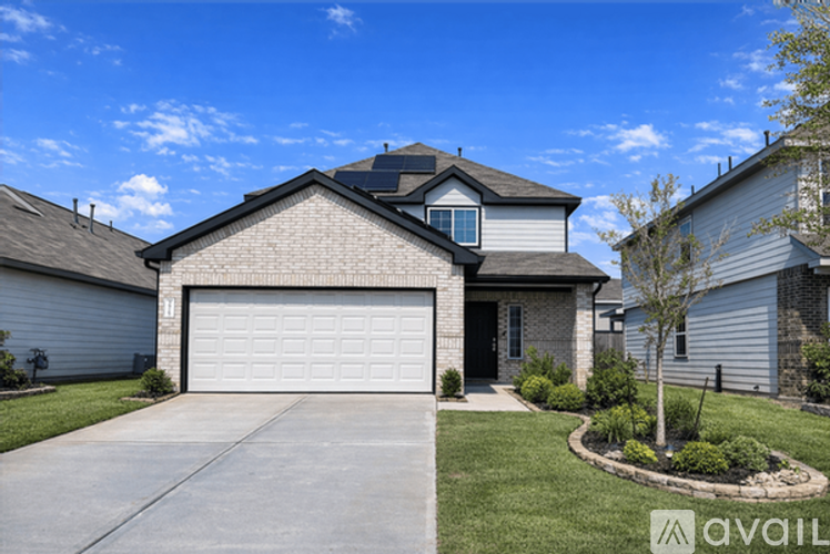 A house with a garage door and a driveway in front.