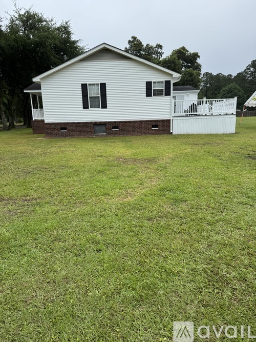 A house with a white fence in front of it.