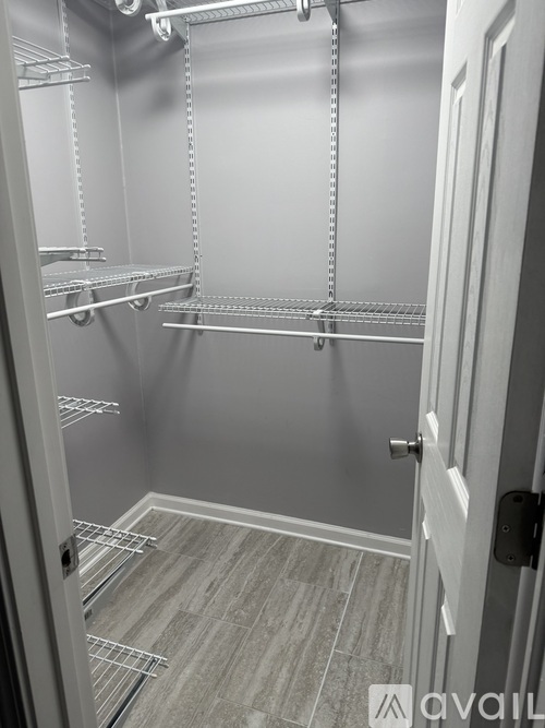 A walk-in closet with shelves and a door.