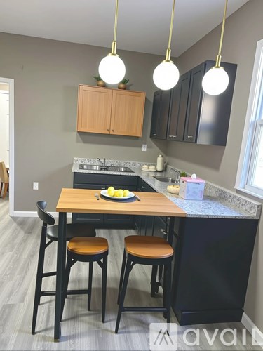 A kitchen with a table and chairs.