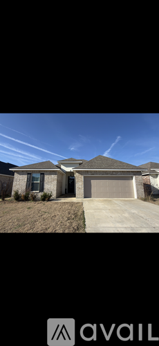 A house with a garage and a driveway is shown.