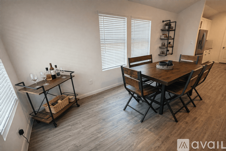 A dining room with a wooden table and chairs.