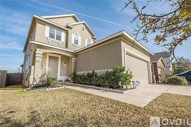 A beige house with a white door and windows is for sale.