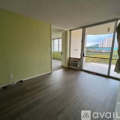 A room with wooden flooring and a green wall.