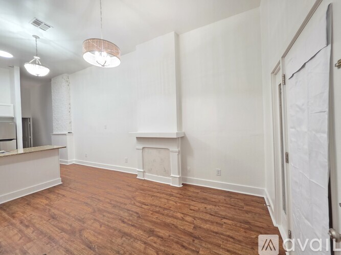 A room with wooden floors and a fireplace.