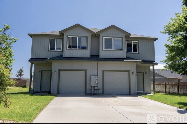A two-story house with a garage is for sale.