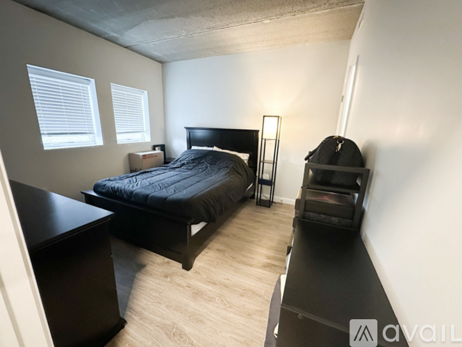 A bedroom with a bed, desk, and chair.