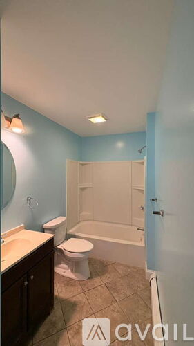 A bathroom with blue walls and a white toilet.