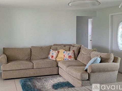 A living room with two couches and a rug.