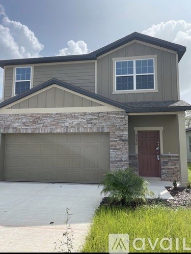 A house with a grey roof and a brown door.