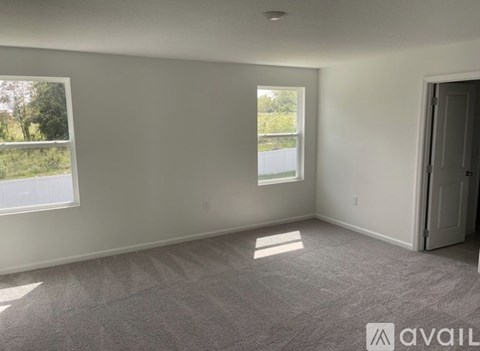 A room with a window and a door is available for rent.