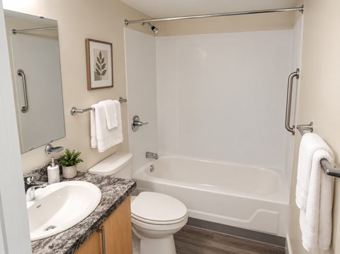 A bathroom with a white toilet, sink, and bathtub.