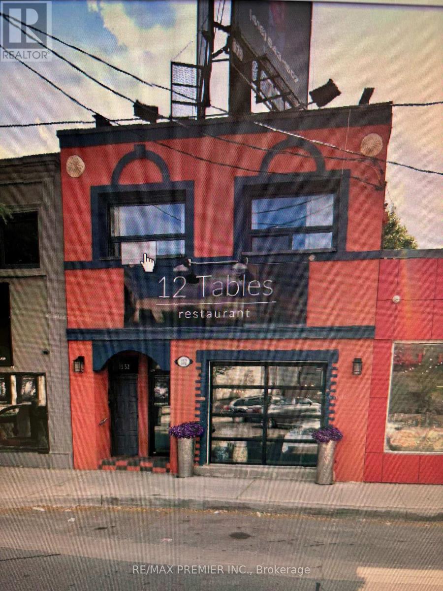 A red building with a sign that says 12 Tables Restaurant.