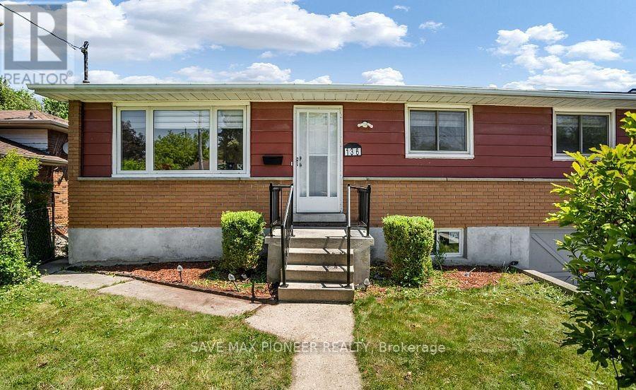 A red brick house with a white door and windows.