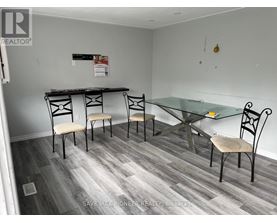 A dining room with a glass table and chairs.