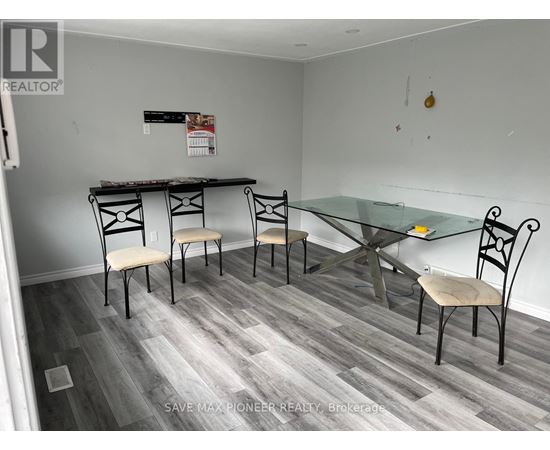 A dining room with a glass table and chairs.