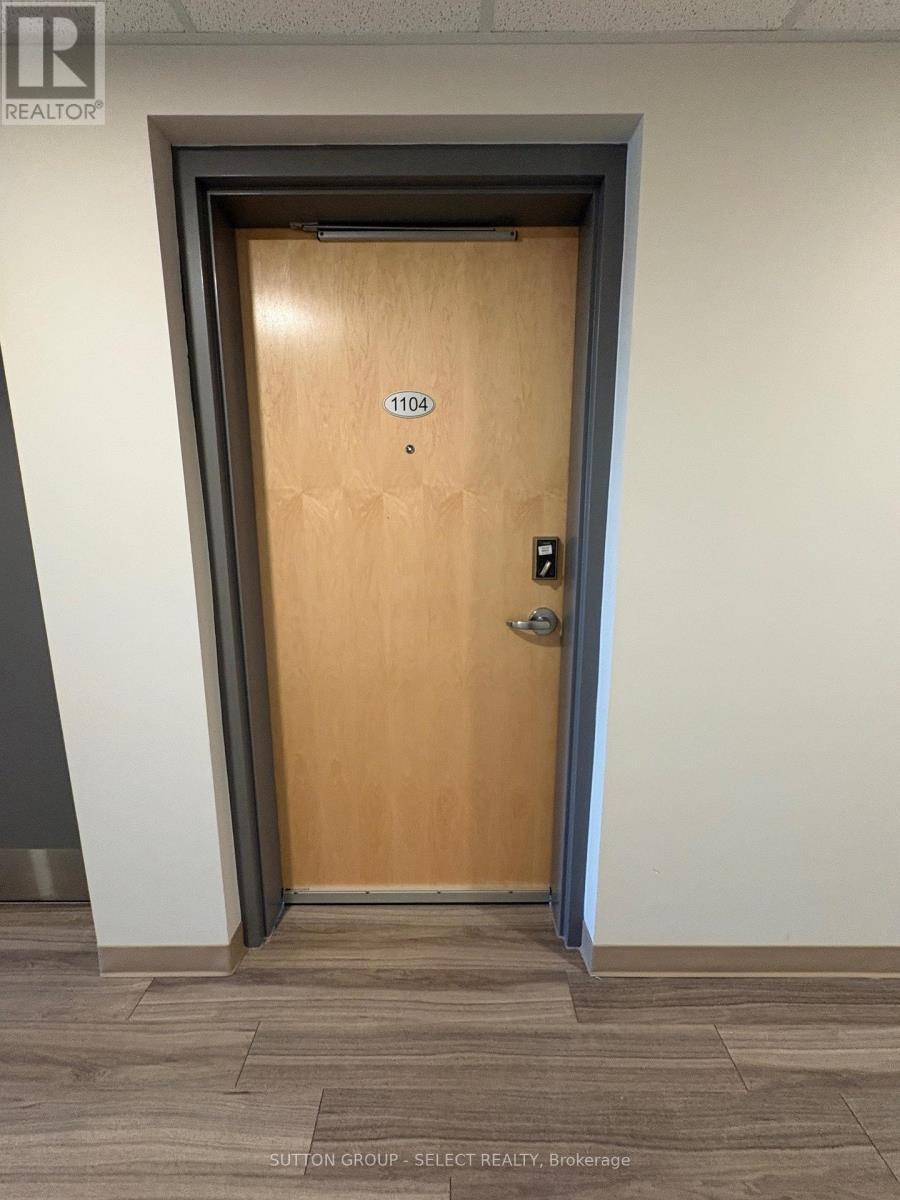 A brown door with the number 1104 on it.