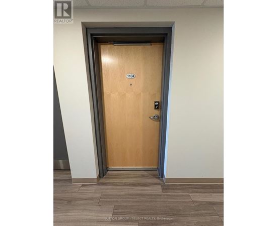 A brown door with the number 1104 on it.