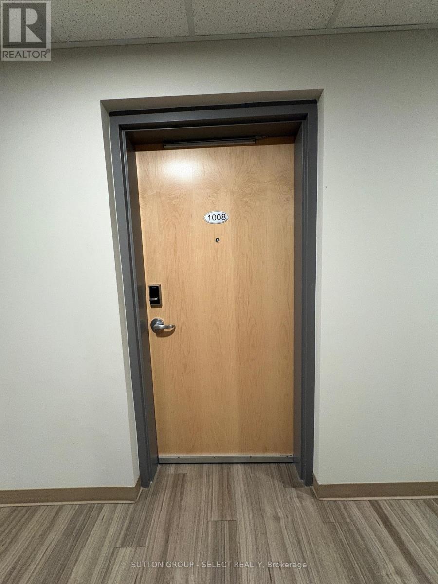 A brown door with the number 1008 on it.