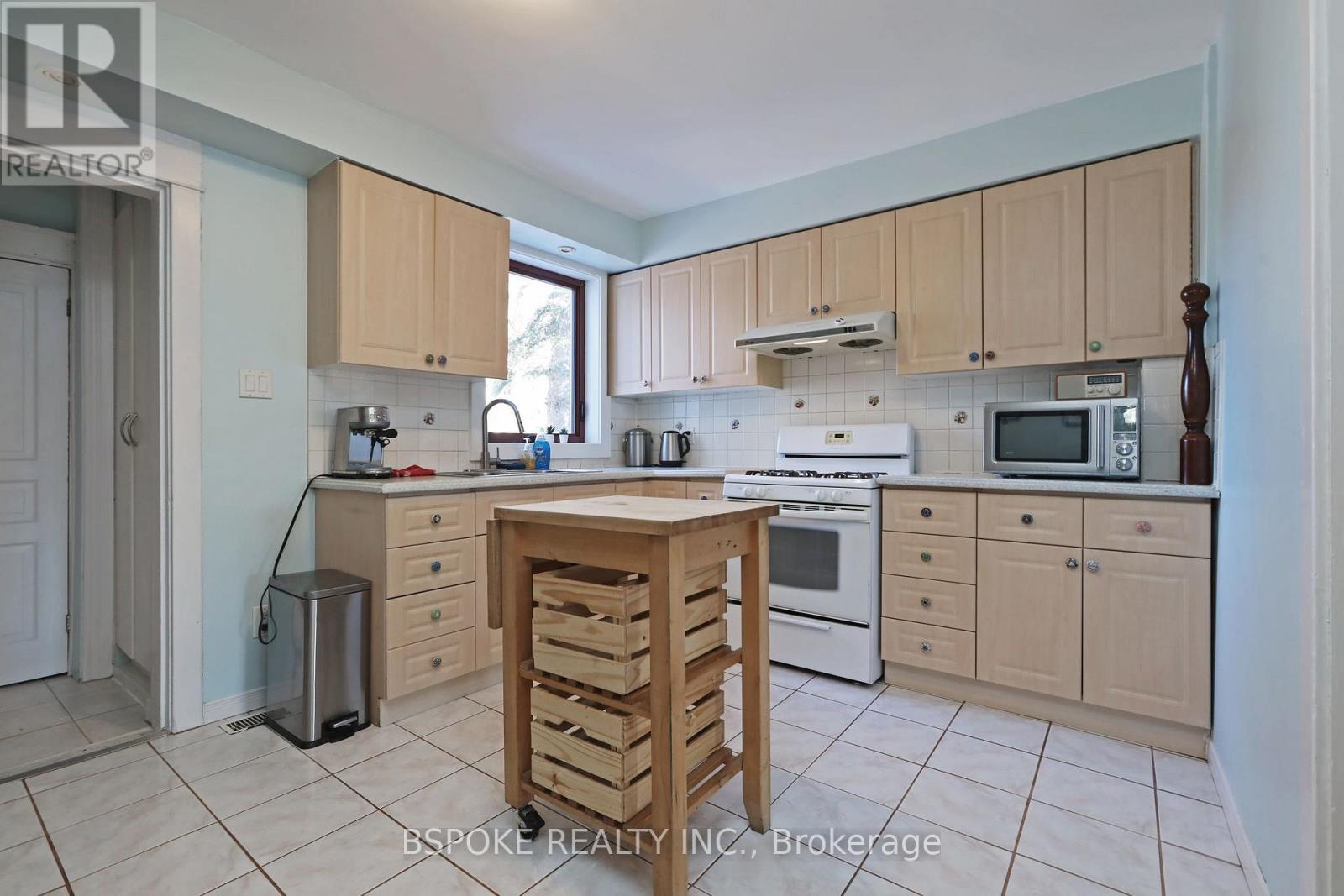 A kitchen with wooden cabinets and appliances.