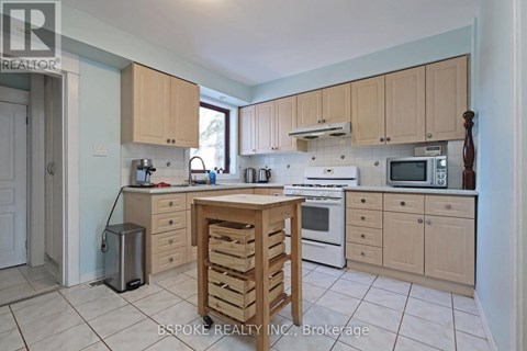 A kitchen with wooden cabinets and appliances.
