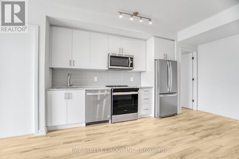 A kitchen with white cabinets and stainless steel appliances.