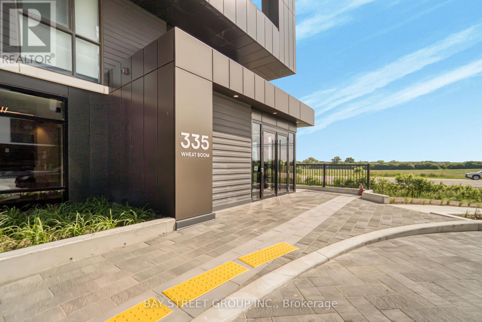 The image shows a modern building with the number 335 and the words "Wheat Stone" on it.