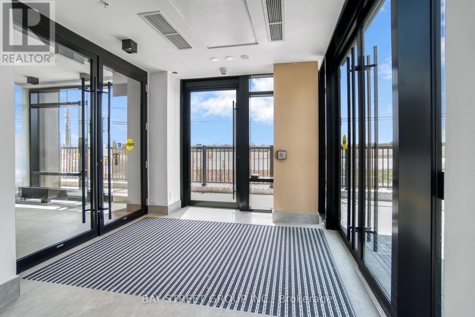 A hallway with a black and white striped carpet.