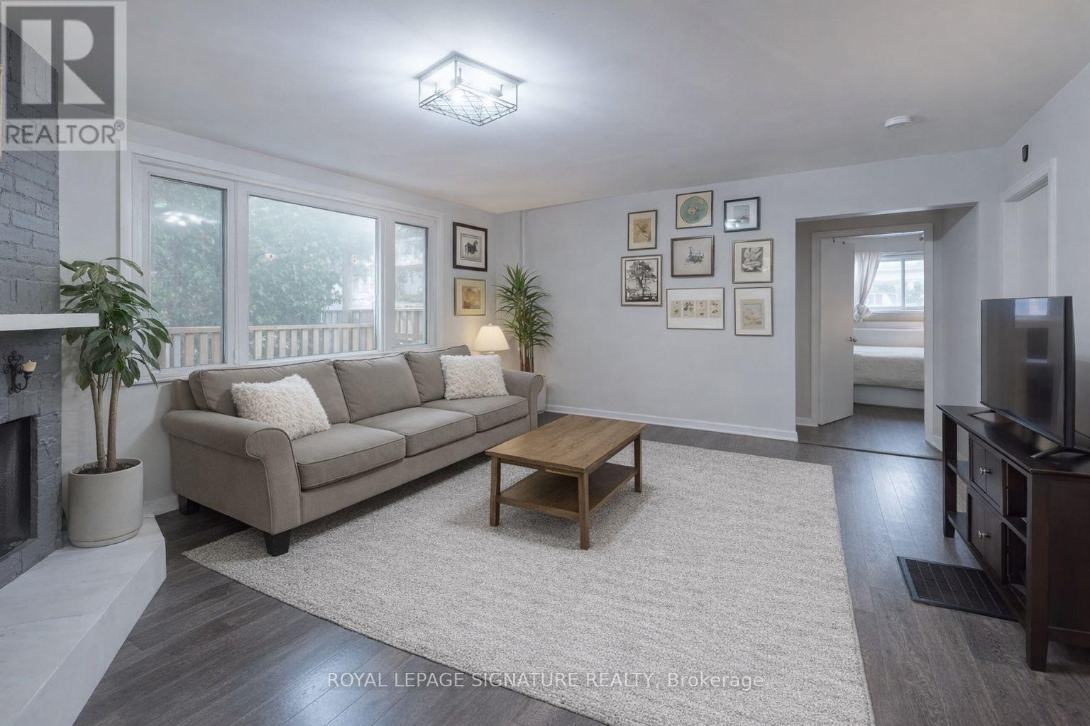 A living room with a couch, coffee table, and pictures on the wall.