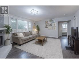 A living room with a couch, coffee table, and pictures on the wall.