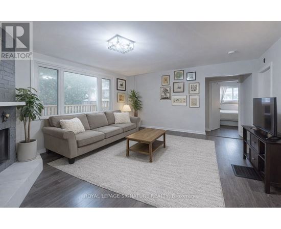 A living room with a couch, coffee table, and pictures on the wall.