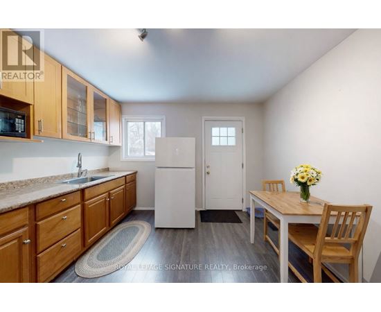 A kitchen with wooden cabinets and a white refrigerator.