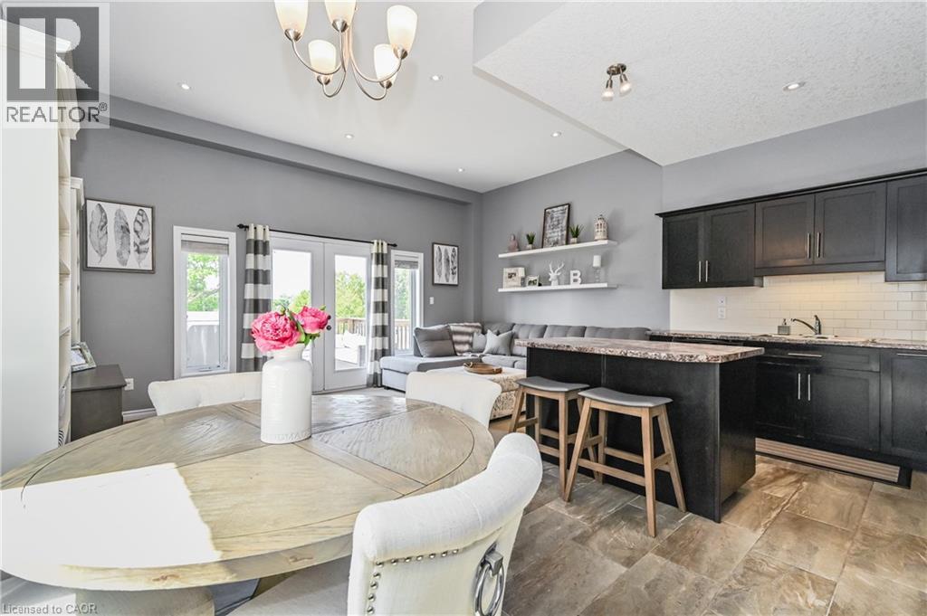 A modern kitchen with a dining table and chairs.