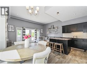 A modern kitchen with a dining table and chairs.