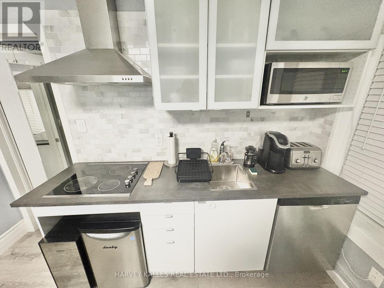 A kitchen with a stove top oven, microwave, and a dishwasher.