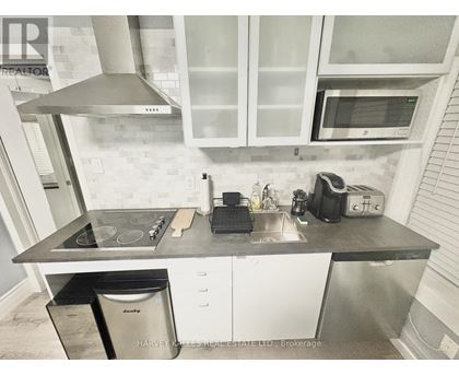 A kitchen with a stove top oven, microwave, and a dishwasher.