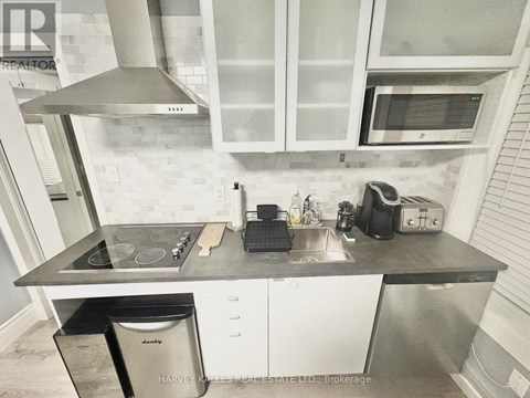 A kitchen with a stove top oven, microwave, and a dishwasher.