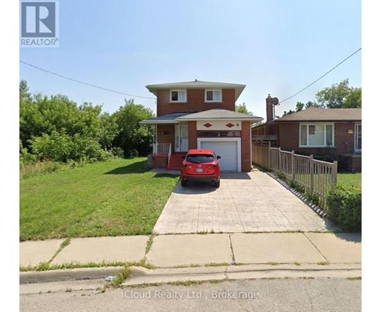 A red car is parked in front of a house with a realtor logo.