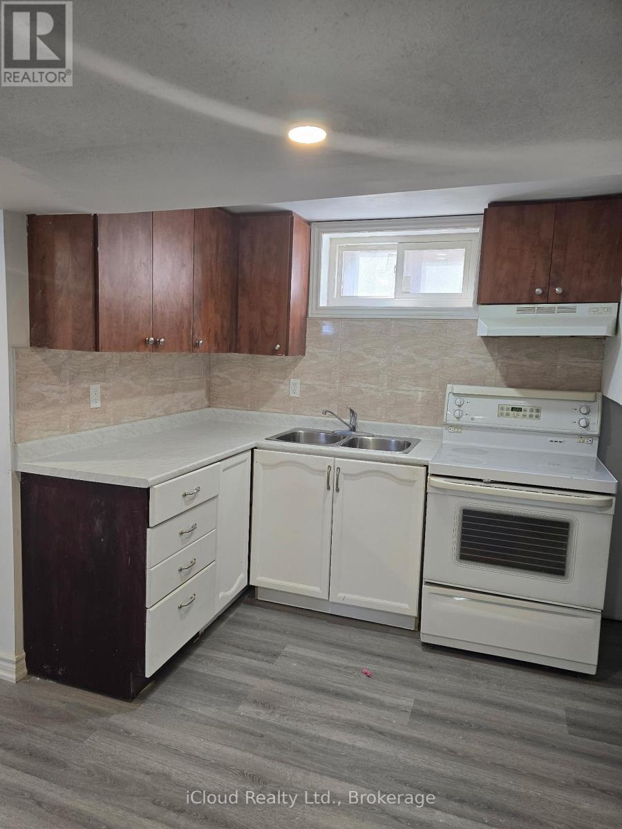A kitchen with white appliances and wooden cabinets.